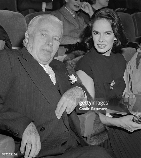 On Other Side of Screen Now. Paris, Franc: Enjoying a busman's holiday, old time film comedian Charlie Chaplin and his wife, Oona, wait for the who...