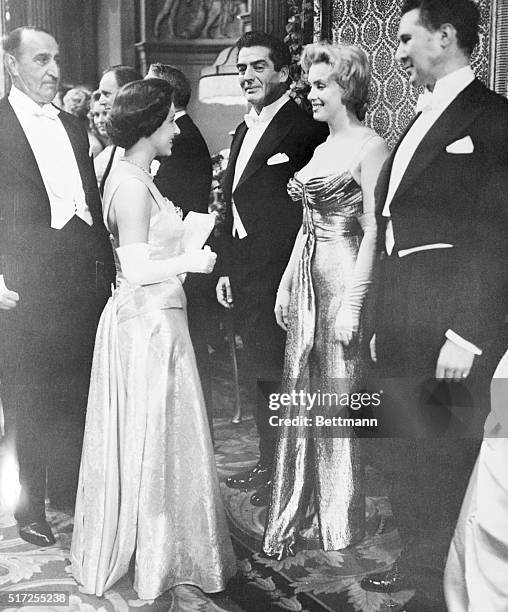 Britain's Princess Margaret chats with Hollywood movie queen Marilyn Monroe before the royal film performance here October 29th. Flanking Marilyn are...