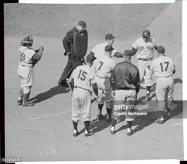 The fifth man in World Series history to hit a Grand Slam Homer, Yankee catcher yogi Berra, crosses home plate after his classic sock in the second...