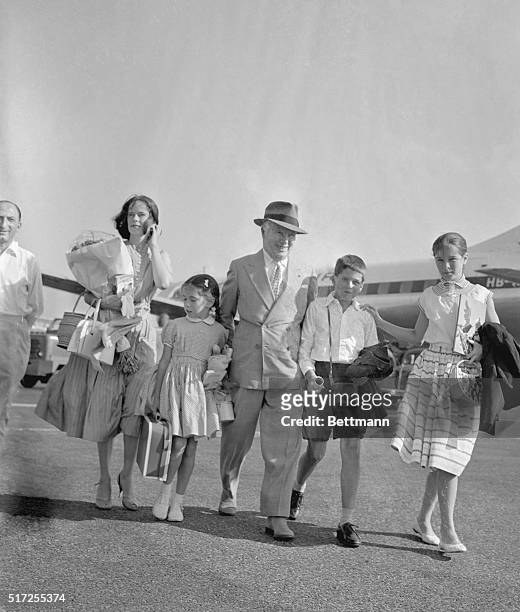 Family Man. Nice, France: Arriving at Nice Airport after a flight from Switzerland, Charlie Chaplin leads his family to the air terminal building....