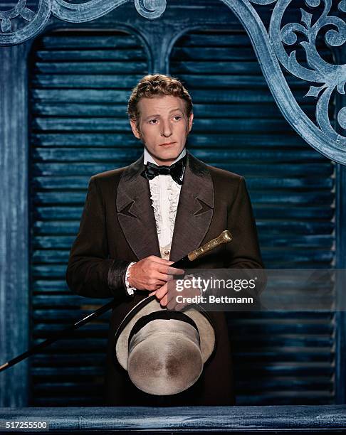 Danny Kaye, looking pensive, holding hat and cane, waist up. SEE NOTE