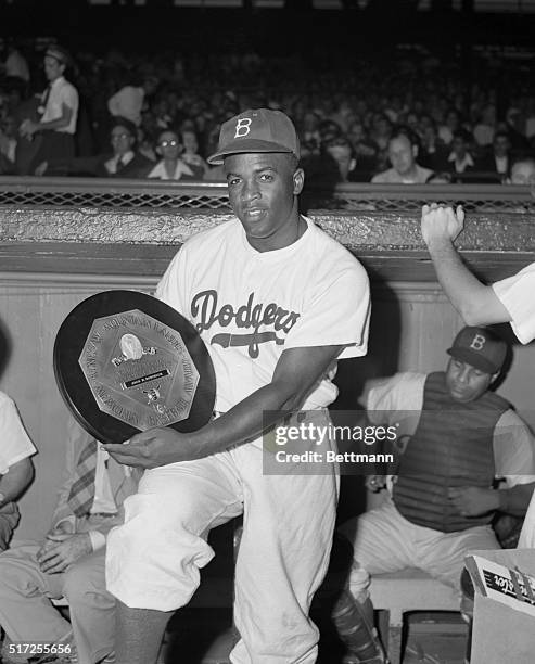 Jackie Robinson Holding Most Valuable Player Award