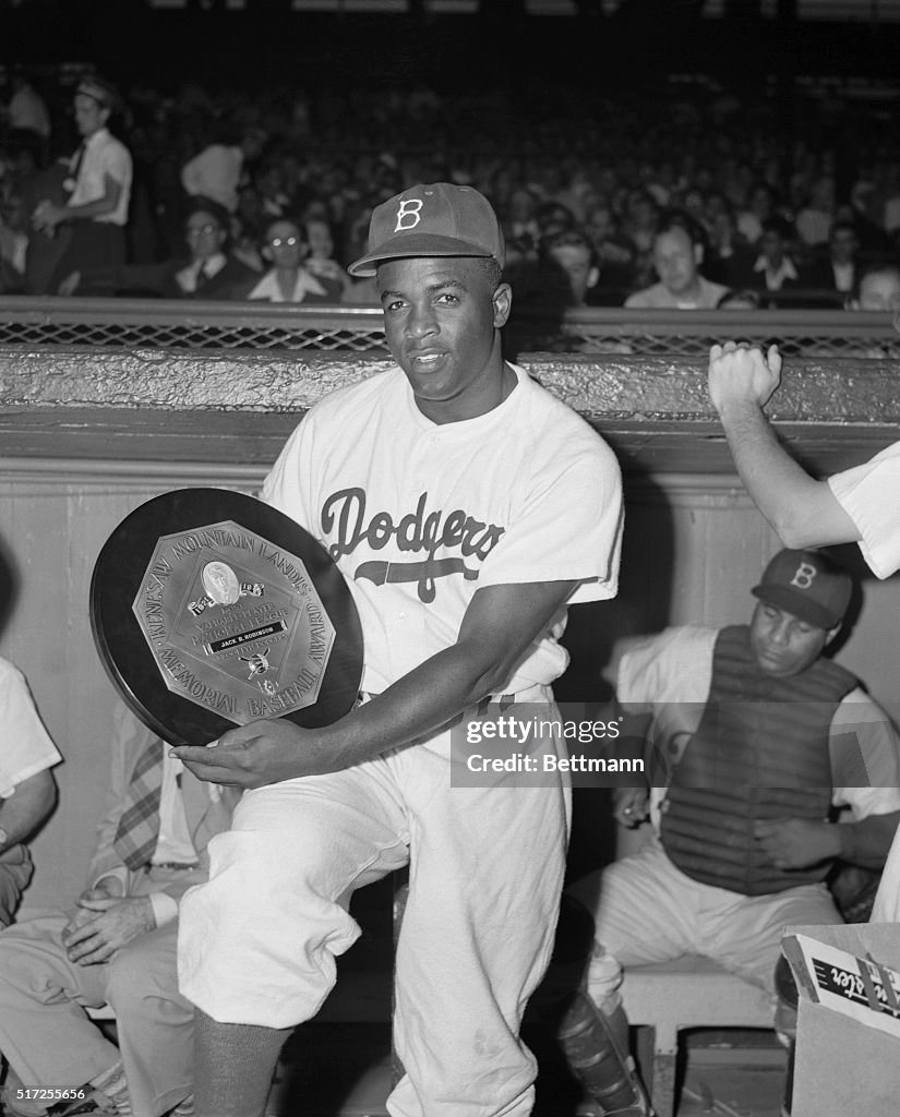 Jackie Robinson Holding Most Valuable Player Award