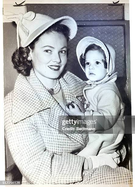 New York, NY- Taking a vacation from film chores, lovely Gene Tierney and daughter, Christina Cassini, wait at LaGuardia Field for Gene's mother to...