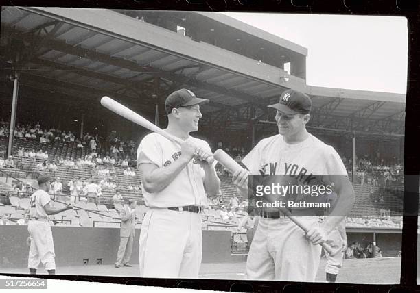 Yankee's Mickey Mantle is in a happier mood during pregame conversation with Red Sox slugger Jackie Jensen, then later on in 4th inning, when he was...