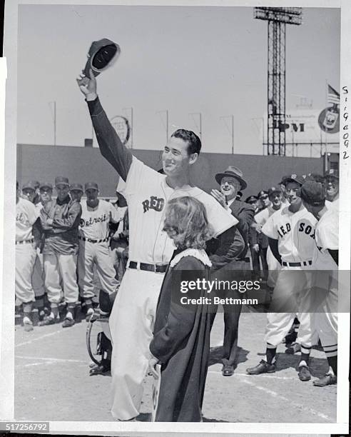 Smiling, cap-waving Ted Williams is shown as he faced some 30,000 cheering fans yesterday at Fenway Park as the Red Sox slugger was honored on his...