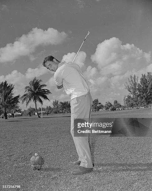 Bobby Thomson, New York Giants third baseman and hero of the Giants-Dodgers playoff before the "51 World Series, warm up on the Miami Country Club...