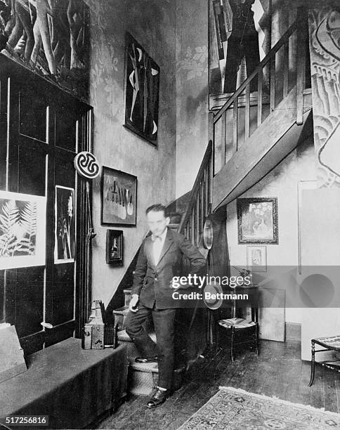 Photo shows American photographer Man Ray standing in his studio when he was at work in Paris in the 1920s.