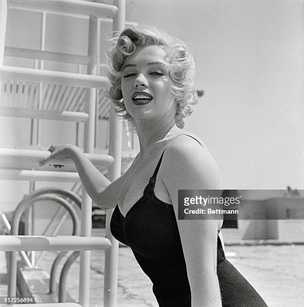 Marilyn Monroe, considered for excellent and obvious reasons Hollywood's most exciting blonde since Jean Harlow, looks curvy and outdoorsy as she is...