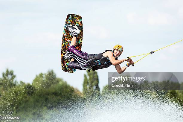 wakeboarder flying - wasserski stock-fotos und bilder