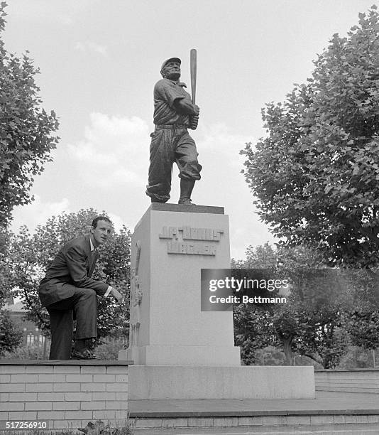 Stan Musial of the St. Louis Cardinals pauses before a statue of Honus Wagner outside Forbes Field after a game with the Pirates. Stan slashed a...
