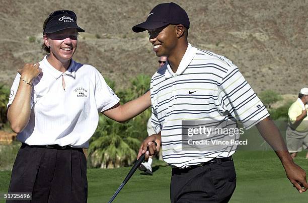 Annika Sorenstam of Sweden talks to teammate Tiger Woods of the US after splitting the first hole with opponents Dvid Duval of the US and Karrie Webb...