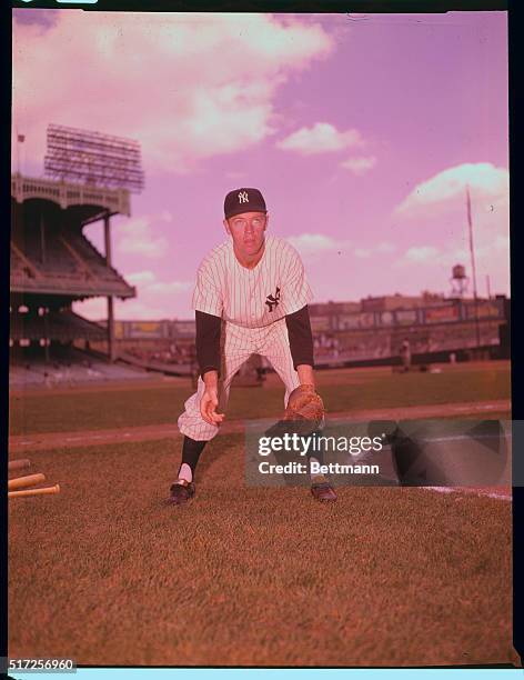 Yankee outfielder Gil McDouglad poses during fielding practice in uniform.