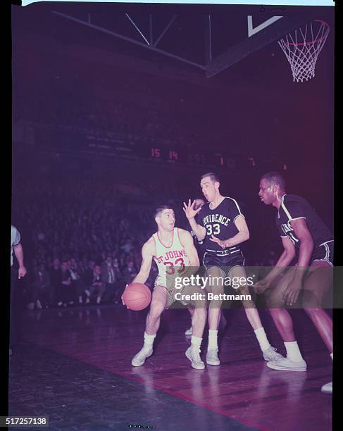 New York, New York: Trying to maneuver his way to the basket is St. John's Alan Seiden in NIT game at Madison Square Garden. Blocking the path are...