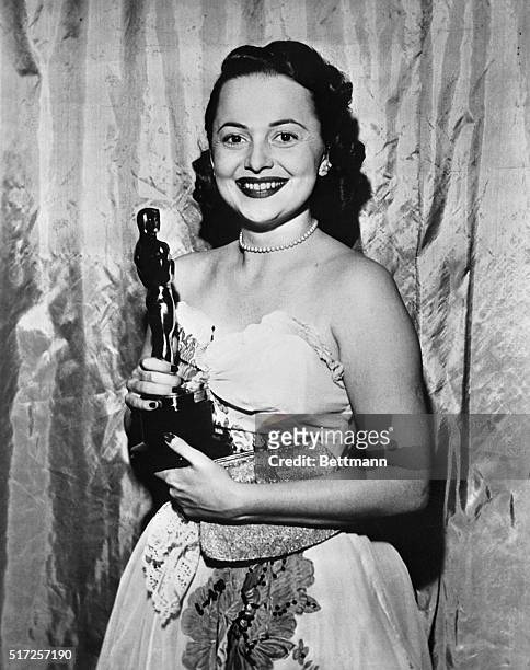 Olivia De Havilland, holding the Oscar she won for her performance in To Each His Own.
