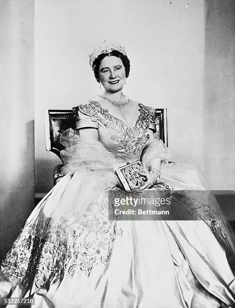 Queen Mother Elizabeth wears a gown of deep oyster satin embroidered with gold, silver and crystal beads in this portrait just issued in London. The...