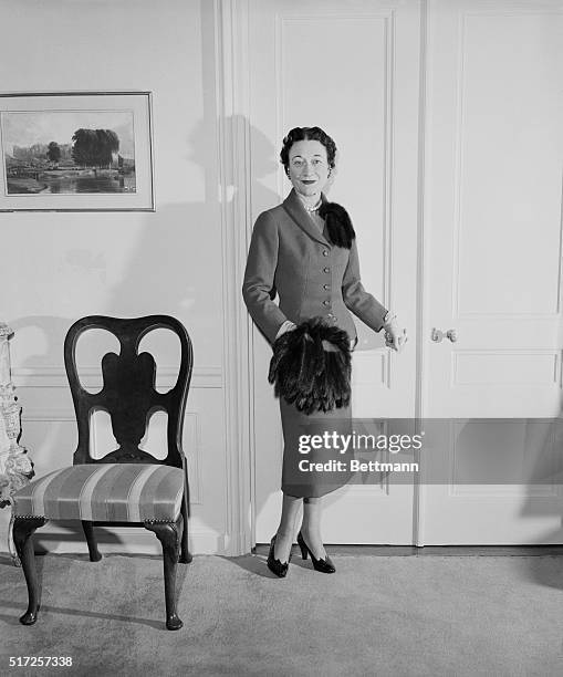 The Duchess of Windsor, who again wins a place in the list of the world's best dressed women, is shown here wearing a blue suit trimmed with fur on...