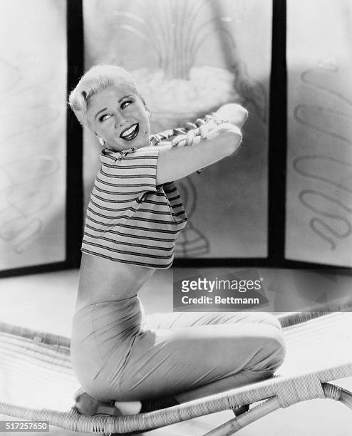 Ginger's in great form...Hollywood, California...In form-hugging pants and loose-fitting blouse, actress Ginger Rogers shows she's in fine shape as...