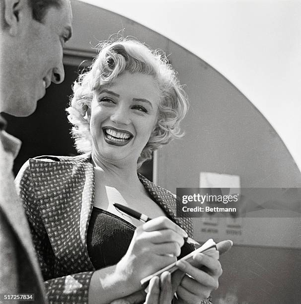 Marilyn Monroe Signing Autograph for Young Man.