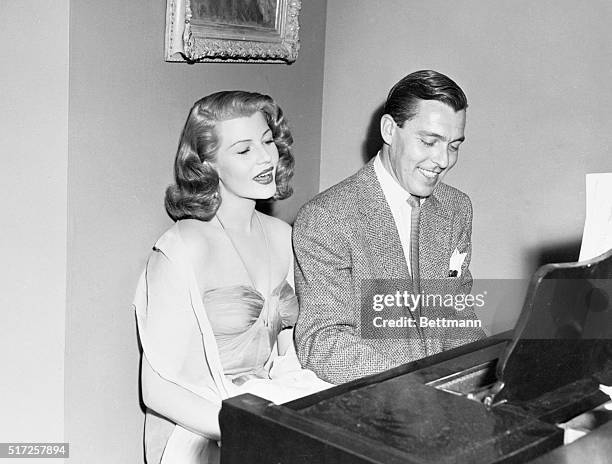 Actress Rita Hayworth at the piano with Columbia Pictures' Fred Karger, on the set of the 1952 film, Affair in Trinidad.