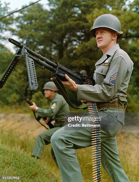 New Army Weapons in Action. Sergeant Harry M. Mayer, foreground with the M-60 Machine Gun and SFC George Evans with the M-14 Rifle demonstrate the...