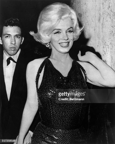 Marilyn Monroe arrives at the Golden Globes with screenwriter Jose Bolanos.
