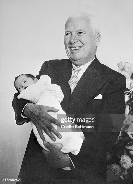 Lausanne, Switzerland: Jolly Charlie Chaplin is a proud papa as he gets to hold his 10th child, James. The baby, born July 8th to the former Oona...