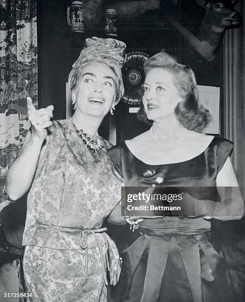 Film stars Joan Crawford and Bette Davis are shown united at party in their honor to celebrate Premier of their new film What Ever Happened To Baby...