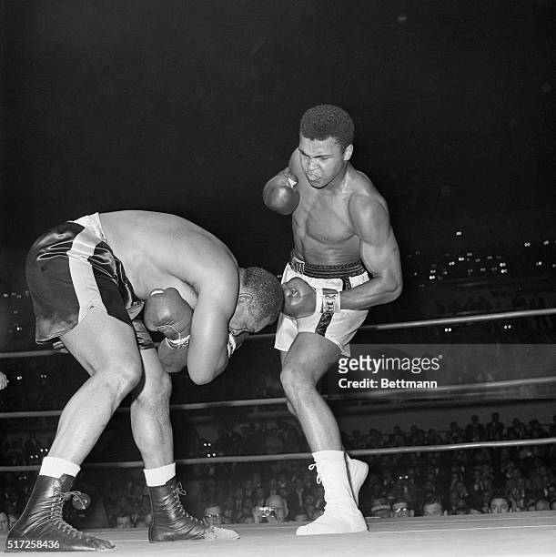 The story of the Cassius Clay-Archie Moore fight is told graphically here as Clay aggressively rushes Moore who covers up and ducks low to avoid...