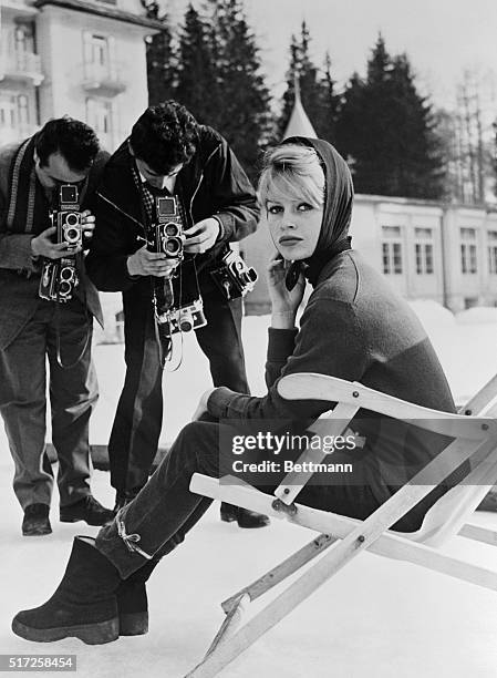 French movie star Brigitte Bardot takes time out from relaxation at the famed resort of Cortina to pose for photographers. The voluptuous beauties'...