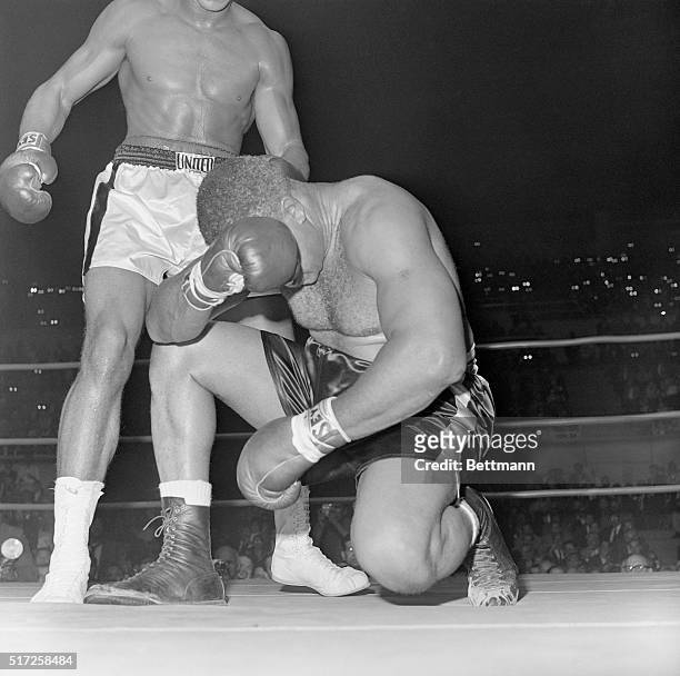 Boxer Archie Moore waits for the count with his head in his hands in the fourth round of a fight with Cassius Clay in 1962. Clay hit Moore twice...