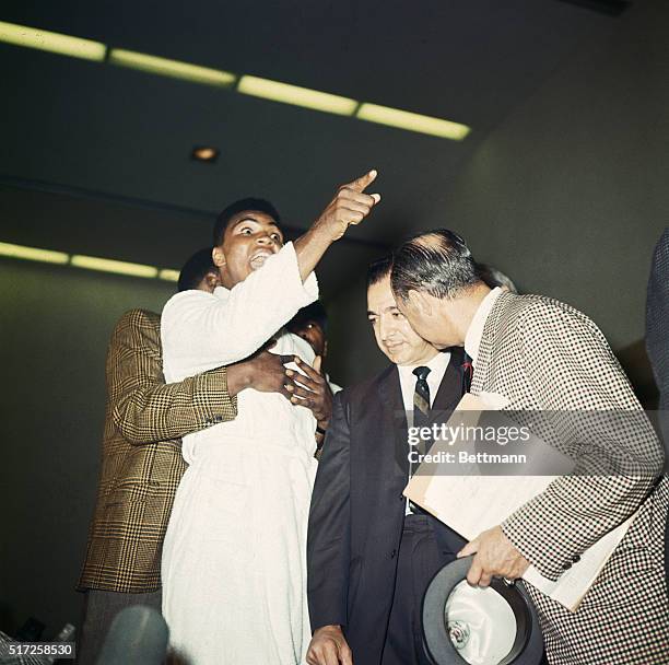 Cassius Clay yells at heavyweight champion Sonny Liston during weigh-in here for their title fight. Clay was fined $2,500 for his "conduct on the...