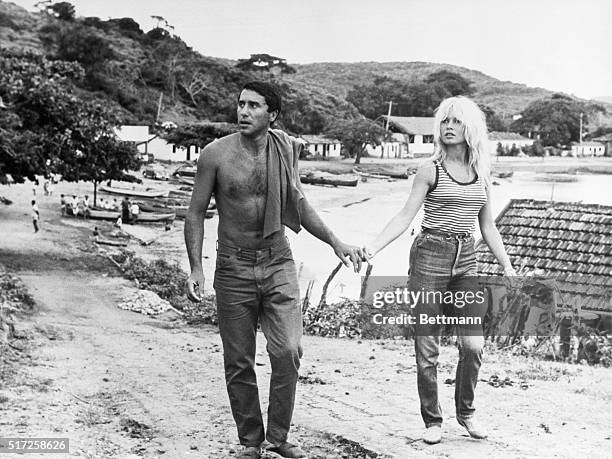 French film queen Brigitte Bardot and her companion, Brazilian-Morrocan Bob Zaguri, stroll hand in hand along the road in this quaint village,...