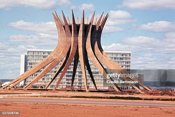 Brasilia, Brazil: The Brasilia Cathedral. Under construction with the government ministry building in the background. UPI color slide.