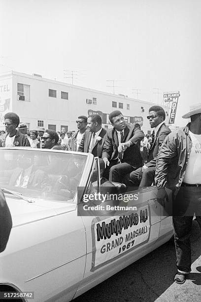 Deposed heavyweight boxing champion Cassius Clay acknowledges the cheers of crowds as he serves as Grand Marshal of a three-hour parade which...