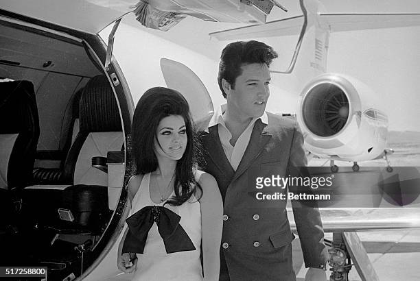 Newlyweds Elvis and Priscilla Presley, who met while Elvis was in the Army, prepare to board their private jet following their wedding at the Aladdin...