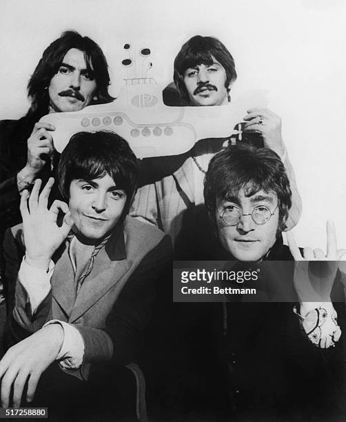 The Beatles hold a submarine during their announcement to make the animated film Yellow Submarine later released in 1968. From left to right: George...