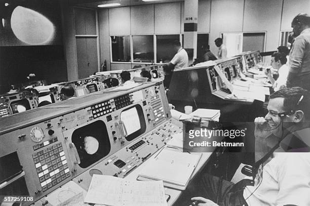 Big Day at Space Center. Space Center, Houston: Flight Director Glynn Lunney sits at his console in Mission Control Center with his face wreathed in...