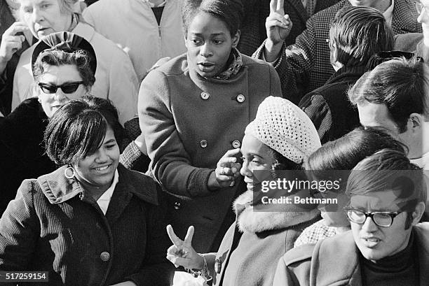 Mrs. Martin Luther King, Jr., makes a "V" for victory sign, as she participates in an antiwar demonstration in Washington, February 6th. She led a...