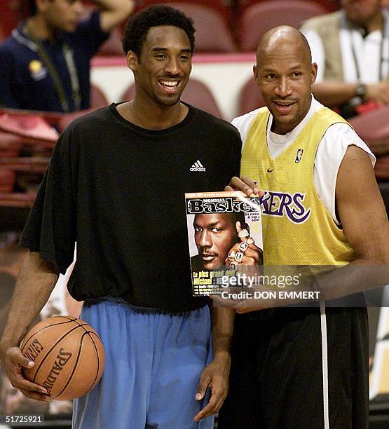 Kobe Bryant and Ron Harper of the Los Angeles Lakers show a copy of a magazine with a picture of Michael Jordan on the cover with his sixth NBA...
