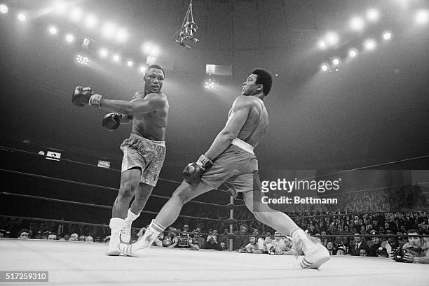 Boxer Muhammad Ali steps away from a punch thrown by boxer Joe Frazier during their heavyweight title fight at Madison Square Garden in 1971. Frazier...