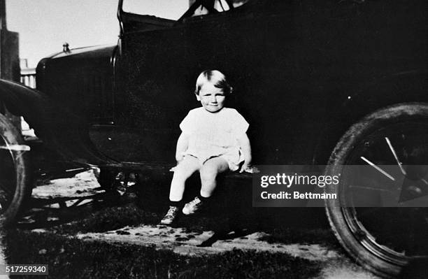 Little Norman Jean Baker is hardly camera shy as she sits on a Model A Ford being photographed. Norma Jean, in later life Marilyn Monroe, found...