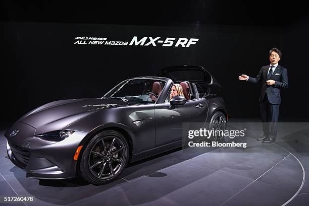 Masahiro Moro, president and chief executive officer of Mazda North America Operations, unveils the Miata MX-5RF convertible vehicle during 2016 New...