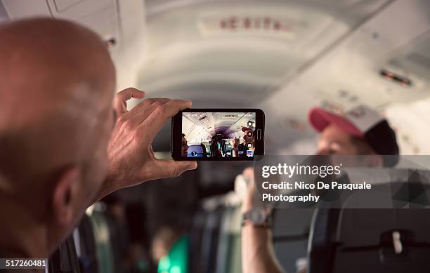 friends on the plane - mobile on plane stock-fotos und bilder