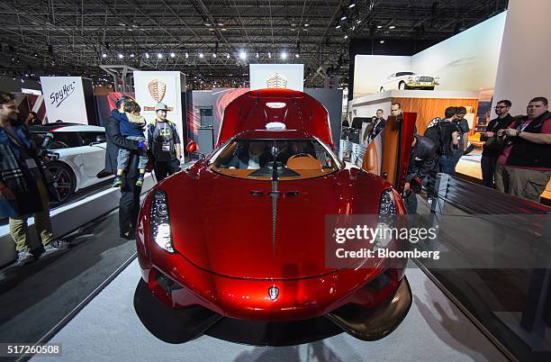 Attendees view the Koenigsegg Automotive AB Regera luxury vehicle during the 2016 New York International Auto Show in New York, U.S., on Thursday,...