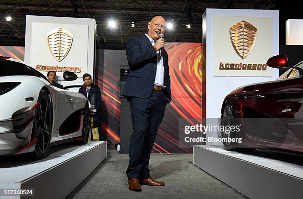 Christian von Koenigsegg, founder of Koenigsegg Automotive AB, speaks while standing next to the Regera luxury vehicle, right, during the 2016 New...