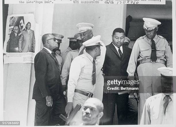 Port-Au-Prince, Haiti: President Jean Claude Duvalier is escorted from the army barracks following an inspection and review, April 26. On the left is...