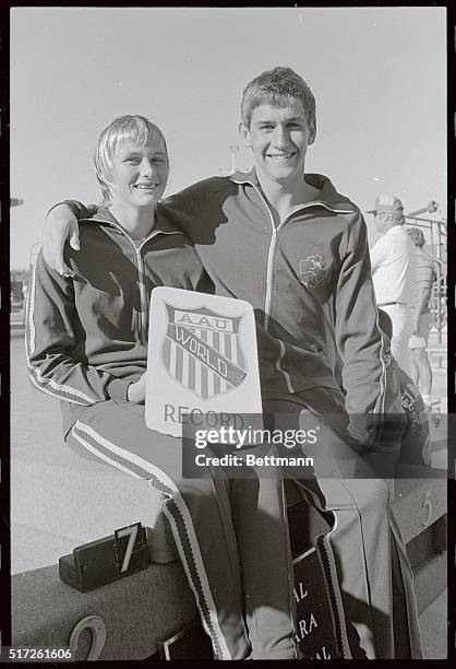 Shane Gould, 14-yr-old sprint sensation from Australia, holds placard proclaiming her world record in the Women's 400 Meter Freestyle event during...