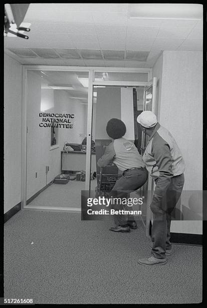 Washington: Workmen remove a soft drink machine from the now famous suite of offices belonging to the Democratic National Committee in the Watergate...