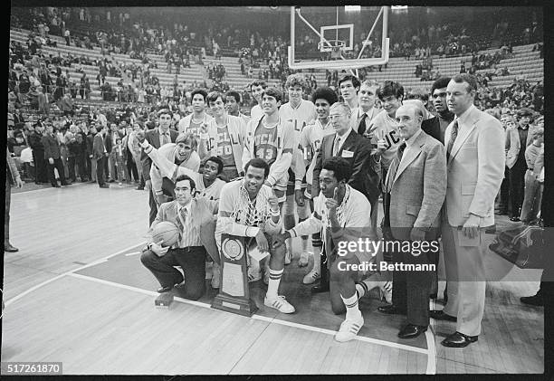 St. Louis: Number one for the seventh straight year, the UCLA basketball team and coaches gather with the NCAA championship trophy after they beat...